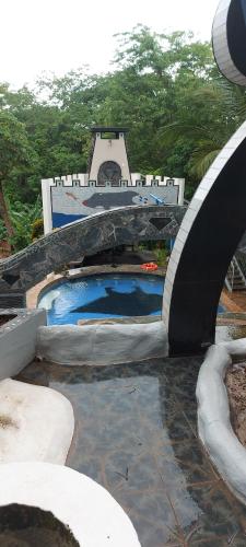a water park with a swimming pool and a bridge at El Castillo Monte Campana in Puntarenas