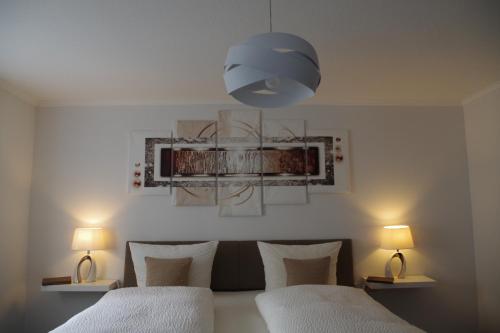 a bedroom with two beds and a blue light at Gast und Weinhof Beim Schneemann in Valwig