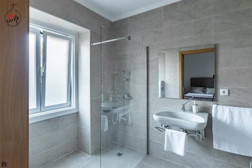 a bathroom with a sink and a glass shower at Quinta da Fortaleza in Elvas