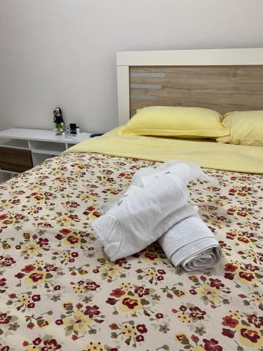 a towel on a bed with flowers on it at Emre Guest Apartment Near İstanbul Airport in Istanbul