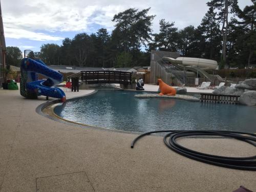 a water park with a water slide in a pool at LE PIPA in Quend
