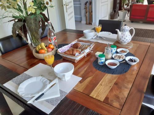 a dining room table with a bowl of food on it at La Clémencerie Chambre d'hôtes in LʼÉtang-la-Ville
