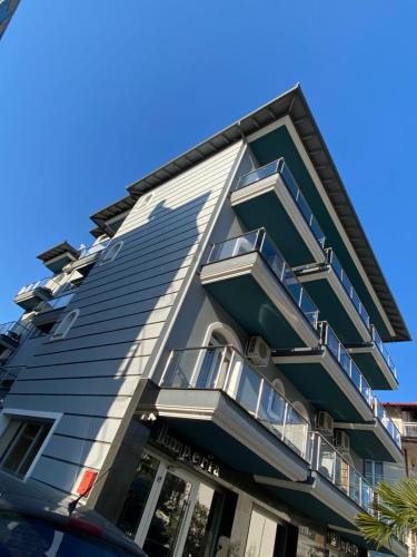 a building with balconies on the side of it at Imperia President in Paralia Katerinis