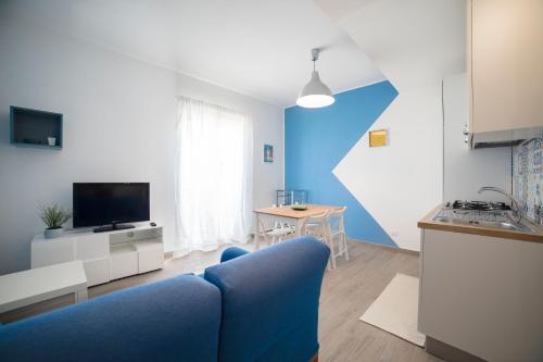 a blue and white living room with a blue couch at GLBapartments in Capo dʼOrlando