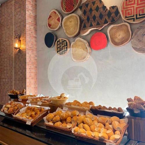 a bunch of different types of breads and baskets on a wall at Ondas Praia Resort in Porto Seguro