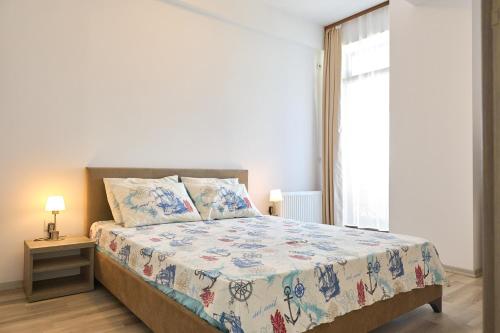 a bedroom with a large bed and a window at Alina Lake View Apartment in Mamaia