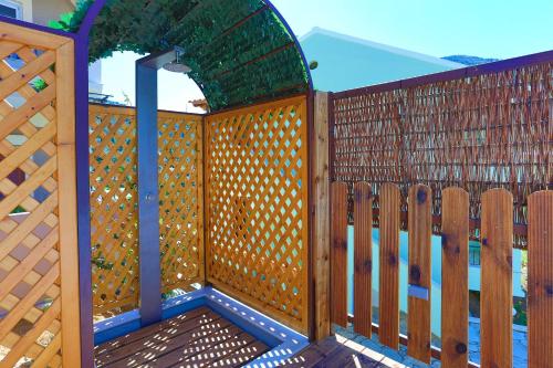 a wooden deck with a gate and a fence at Villa Kadith Agios Gordios in Agios Gordios