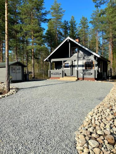 a house with a gravel driveway in front of it at Playa del Finland in Peräseinäjoki