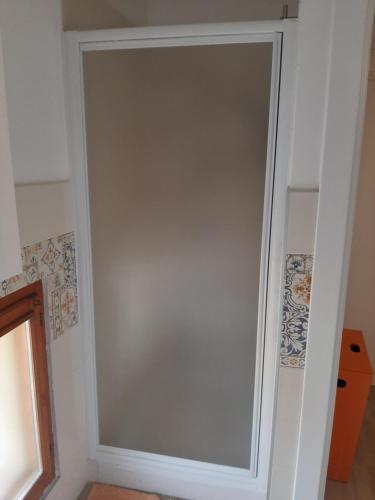 a sliding glass door in a white wall at B&B I GEMELLI in Sorbolo