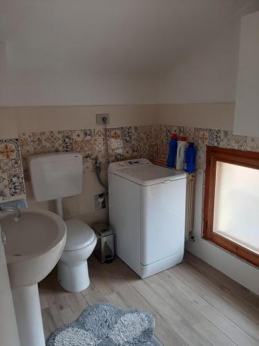 a small bathroom with a toilet and a sink at B&B I GEMELLI in Sorbolo