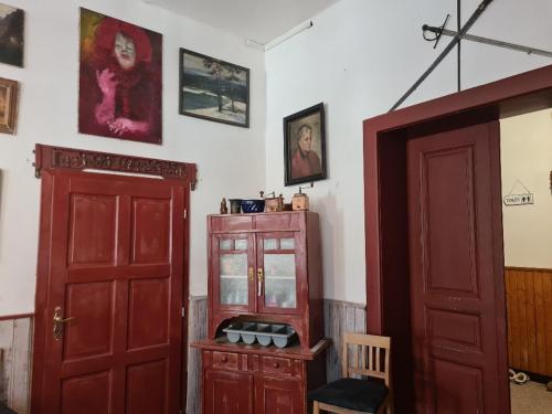 a room with a red door and a cabinet at HORSKÝ PENZION U SPLAVU in Josefuv dul