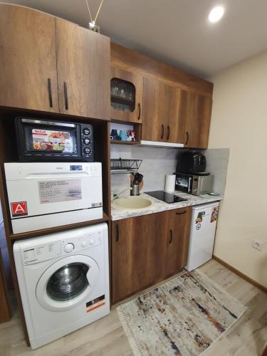 a small kitchen with a washing machine and a sink at Malavi DV2 top center apartment Ruse in Ruse