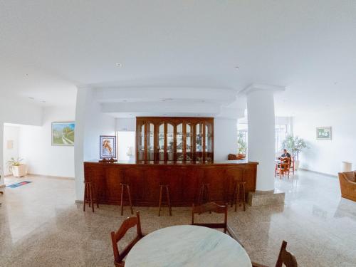 a living room with a wooden altar and chairs at Hotel Recanto dos Pássaros in São Sebastião