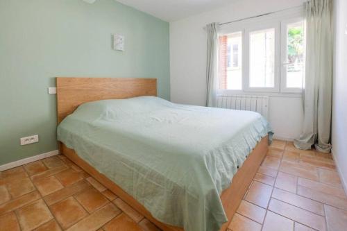une chambre avec un lit dans une pièce avec une fenêtre dans l'établissement Appartement centre ville St Maxime, plage à pied, à Sainte-Maxime