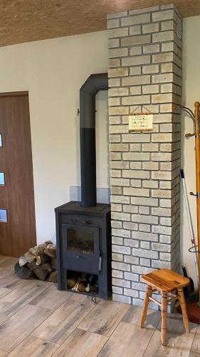 a brick fireplace with a stove in a room at Agroturystyka Kaszuby in Wojsk
