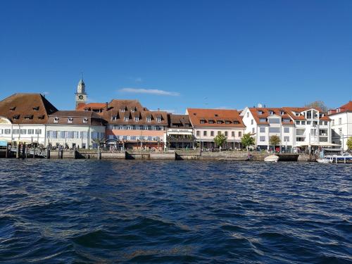 a group of buildings next to a body of water at Loft Orchidee in Überlingen