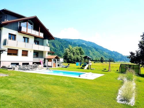 a large house with a swimming pool in a yard at Nico's Place in Jenig