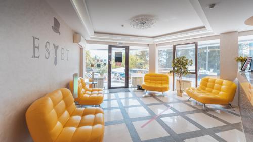 a living room filled with couches and chairs at Estet Hotel in Sochi