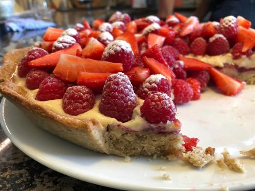 a pie with fruit on top of it on a plate at Villa 7 in Flachau