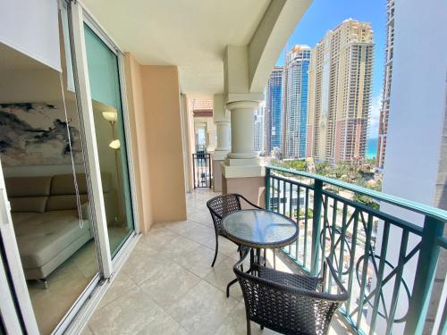 a balcony with a table and chairs on a balcony at The King David Condos in Miami Beach