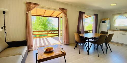 a living room with a table and a kitchen with a door at Vita Mia in Pazin