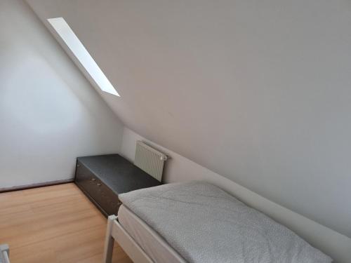 a room with a bed and a bench in a attic at Ferienwohnung/Monteurwohnung Alte Scheune bei Kassel in Weimar