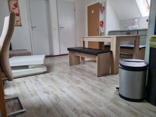 a living room with a table and a stool at Ferienwohnung/Monteurwohnung Alte Scheune bei Kassel in Weimar