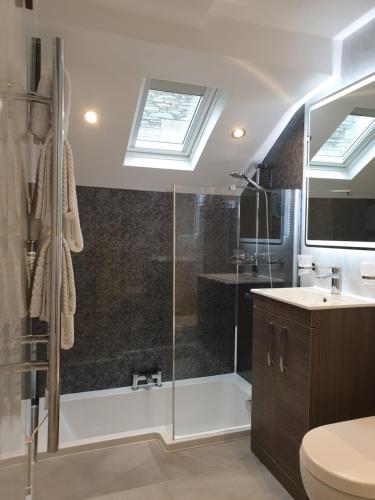 a bathroom with a shower and a sink at Compston House B & B in Ambleside