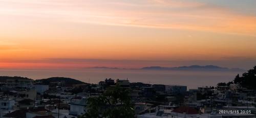 a view of a city at sunset at Rustic House in Émbonas