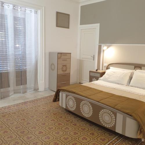 a bedroom with a large bed and a window at Opera Prima 28 in Palermo