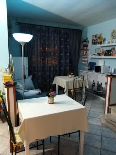 a living room with a table and chairs and a room with a table at B&B Il Girasole in Assemini