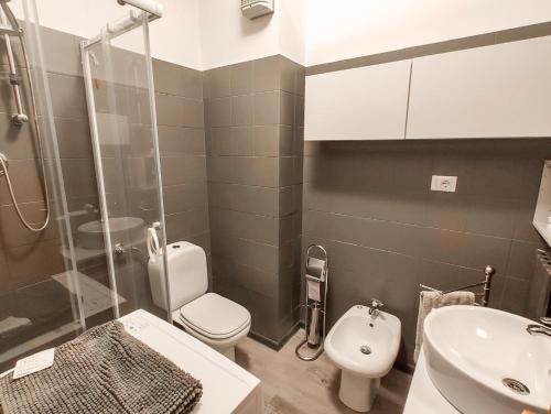 a bathroom with a toilet and a sink and a shower at Finestra sul mare in Lido di Fermo