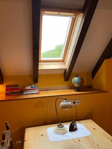 a desk with a lamp and a window at La Borda del Tío Nicolás - Selva de Irati in Aribe