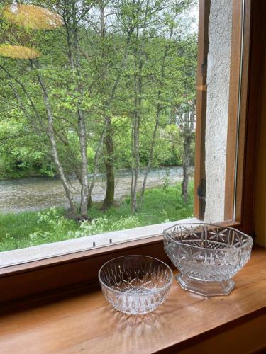 two glass bowls sitting on a window sill at La Borda del Tío Nicolás - Selva de Irati in Aribe