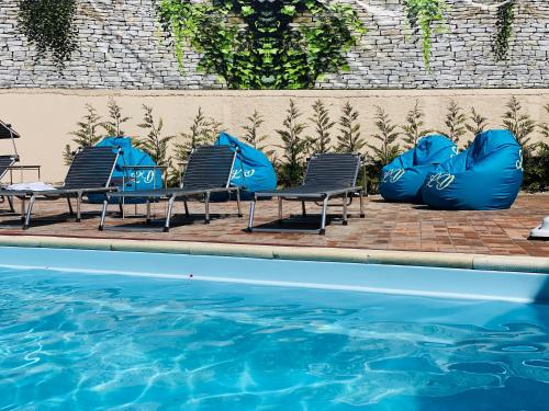 a group of chairs next to a swimming pool at Casa Lacul Doamnei in Ocnele Mari