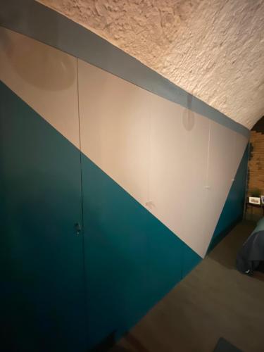 a room with a blue and white wall at Casa Velata a Spaccanapoli in Naples