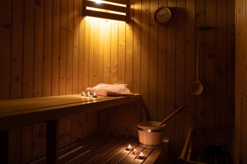 a room with a sauna with lights and a bucket at Haus Klebern, Egg - im Zentrum des Bregenzerwaldes in Egg