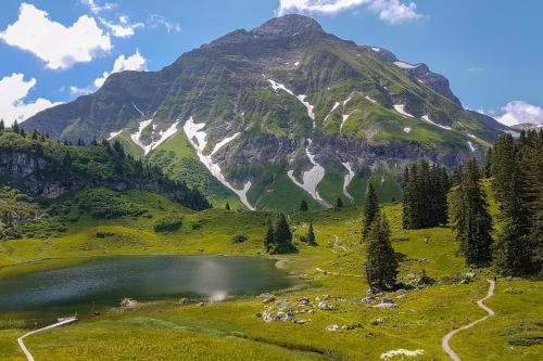 a mountain with a lake in front of it at Haus Klebern, Egg - im Zentrum des Bregenzerwaldes in Egg