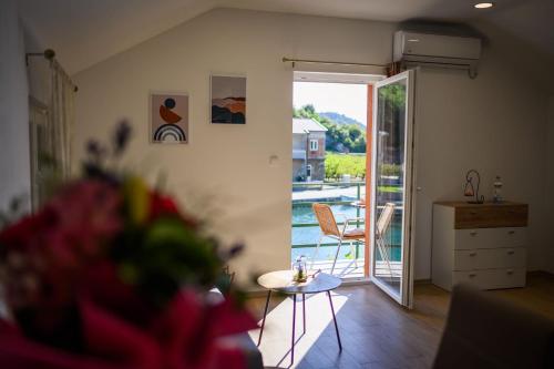 a living room with a door open to a patio at Bonaca in Rogotin