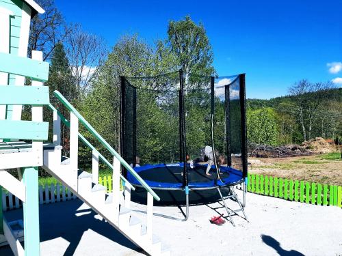 a person on a trampoline on a playground at Kolorowe Karkonosze in Przesieka
