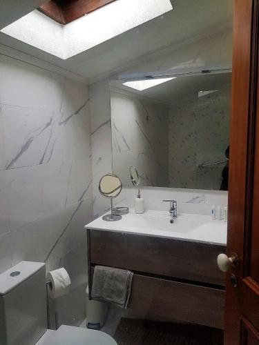 a bathroom with a sink and a mirror at Beautiful Country House&Romantic Garden in Sintra