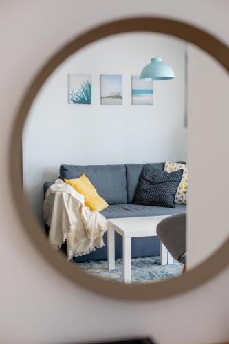 a living room with a blue couch and a table at Apartments Left & Right with jacuzzi, 4 stars in Makarska