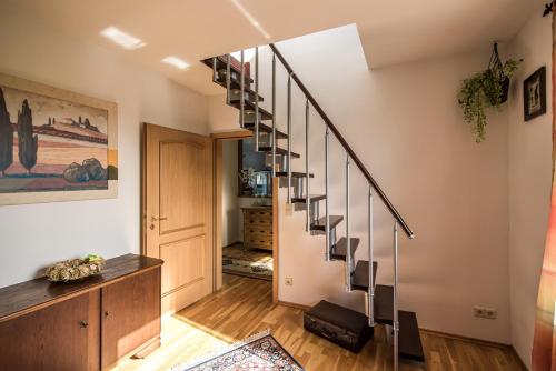 a spiral staircase in a home with wooden floors at Hussi's Home in Großenhain