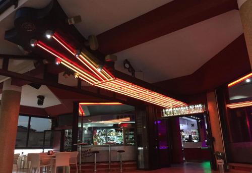 a restaurant with a bar with lights on the ceiling at Sesto Senso Home in Santa Maria del Cedro