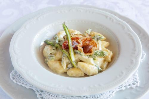 a white bowl of pasta with shrimp and asparagus at Tourist farm Pri Andrejevih in Narin