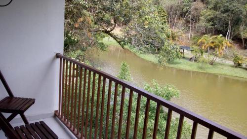 a balcony with a view of a river at Pousada Valle dos Pássaros in Penedo