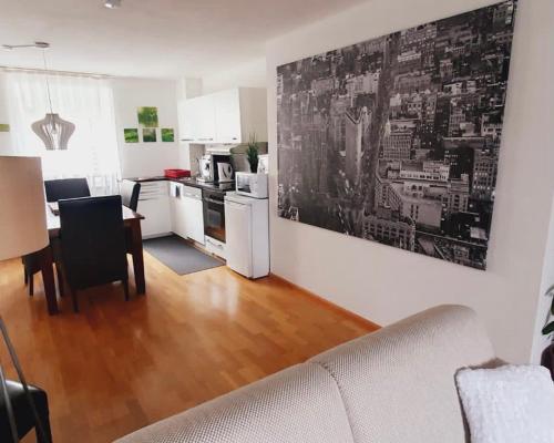 a living room with a kitchen and a dining room at Ferienwohnung Rheinfelden (Beuggen) in Beuggen