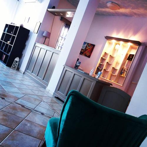 聖佩萊雅基提拉的住宿－繆斯9號酒店，客厅配有绿色椅子和瓷砖地板