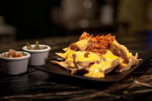 a plate of food with chips on a table at InHouse Hotel Culiacán in Culiacán