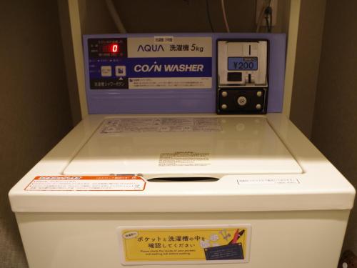 a machine is sitting on top of a refrigerator at Hotel Route Inn Osaka Izumi -Kishiwada Izumi Inter- in Izumi